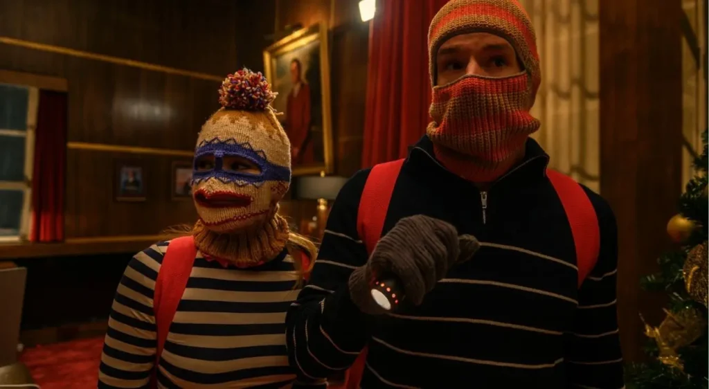 A still image of Connor Swindells and Olivia Holt in Netflix 2025 film Jingle Bell Heist